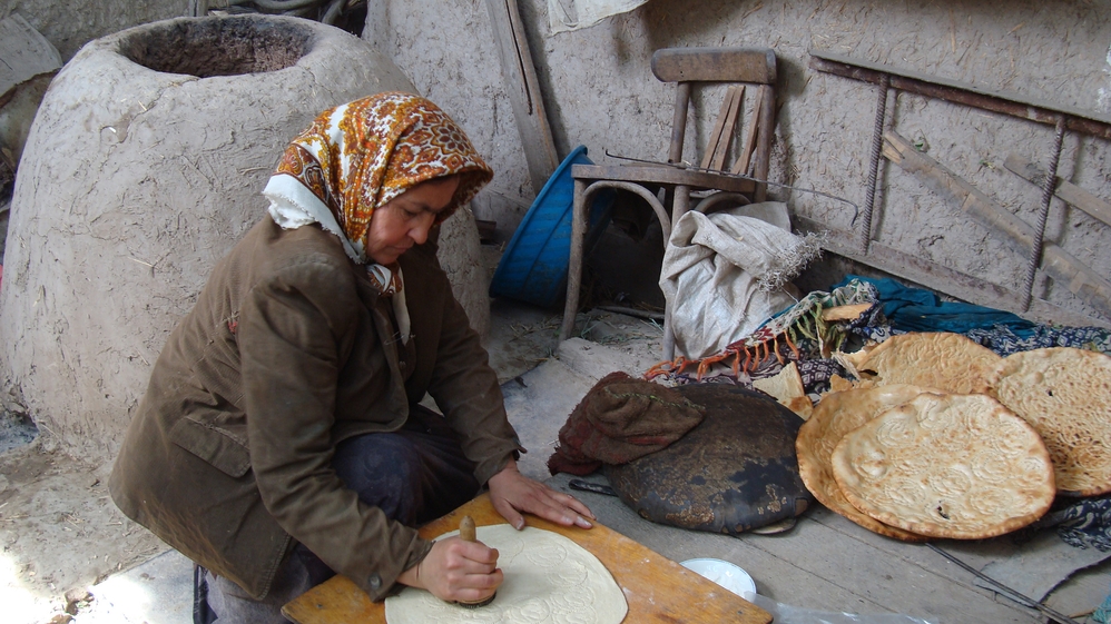 Baking traditional Uzbek bread in the backyard oven